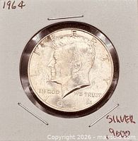 Obverse of 1964 Kennedy half dollar in holder