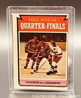 Front view of O-Pee-Chee card in sleeve showing Rangers vs Canadiens action image