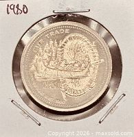 Coin obverse in holder showing FUR TRADE design and 1980 date