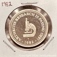 Obverse of 1982 Arthritis Society token shows microscope design and date