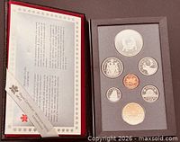 Open presentation case showing certificate and seven proof coins