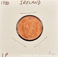 Obverse view of 1990 Irish 1p in holder showing harp and date