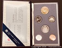 Open presentation case showing six specimen coins and certificate