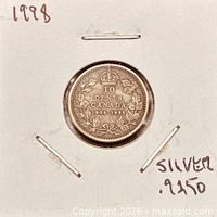 Coin in cardboard holder showing reverse design