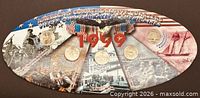 Front view of oval 1999 commemorative display showing all five state quarters
