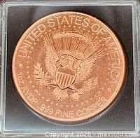 Obverse of copper round in capsule showing eagle and denomination