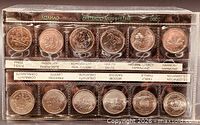 Full view of sealed 12-coin millennium quarter set showing both rows and labels