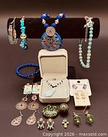 Full display of assorted jewelry items on stand and surface