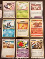 Front view of nine Pokémon cards in sleeves