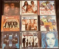 Front covers of the nine pop CDs arranged in grid