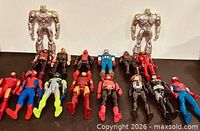 All sixteen action figures displayed, two standing, fourteen lying