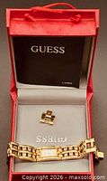 Watch inside red Guess box with spare link