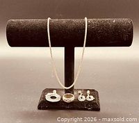 Full set on display stand: necklace, pendant, ring, earrings