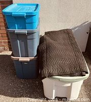 Stack of three Rubbermaid totes showing colours and lids