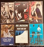 Front view of all six cassette albums in cases