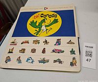 Front of folder showing "Oh! Canada" title, cartoon bird, icon strip