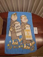 Full view of tea towel on table showing entire design