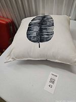 Front view of pillow showing leaf design and overall appearance