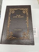 Closed decorative book box showing full cover design and size reference