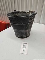 Overall view of galvanized metal bucket front and side