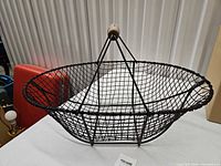 overall view of oval black wire basket on table