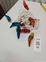 Coiled 8-bird parrot light string on table
