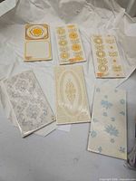 Group shot of all six patterned tiles on packing paper