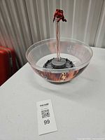 Full view of bowl base, central rod, astronaut figure