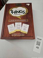 Front of wood-look box with game title medallion