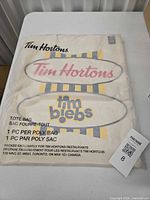 Front of sealed Tim Hortons x Justin Bieber tote in poly bag
