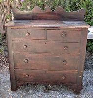 Front view showing full chest, five drawers, backsplash