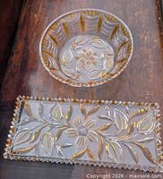 Top view of round bowl and rectangular tray showing gold-highlighted cut designs