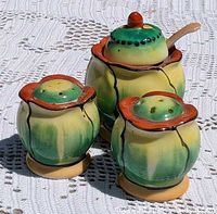 Full view of three ceramic pieces showing colors and design