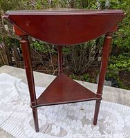 Full view of triangular Bombay table showing drop-leaf sides, three legs and lower shelf