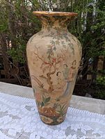 Full view front of tall hand-painted ceramic vase