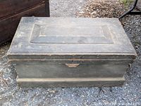 Front angled view of pine chest showing lid panel, base molding and surface wear