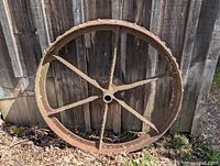 Full view of wheel leaning against wooden wall