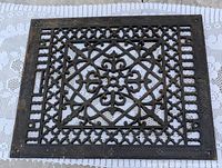 Full view of rectangular cast iron grate showing lattice pattern and dimensions