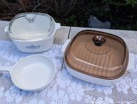 All three CorningWare dishes with lids visible