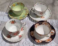 Top view of four assorted teacup and saucer sets displayed