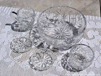 Full view of all five cut crystal pieces on lace cloth