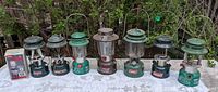Group shot of all eight Coleman lanterns on table