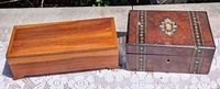 Both wooden trinket boxes side by side on lace cloth