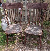 Both oak pressback chairs front view show overall design and condition