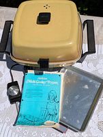 Overall view showing multi cooker frypan with lid, probe, manual, tray