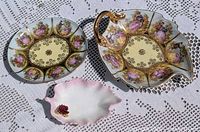 All three dishes displayed on lace cloth: German oval plate, German leaf-form handled dish, Denton leaf dish