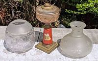 Oil lamp base centered between both glass shades