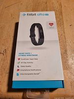 Retail box front showing Fitbit Alta HR branding and features