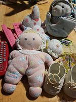 Wide view showing plush doll, remotes, shoes, various plush toys