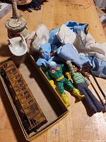 Group shot showing clothing, figures, boxcar and sink